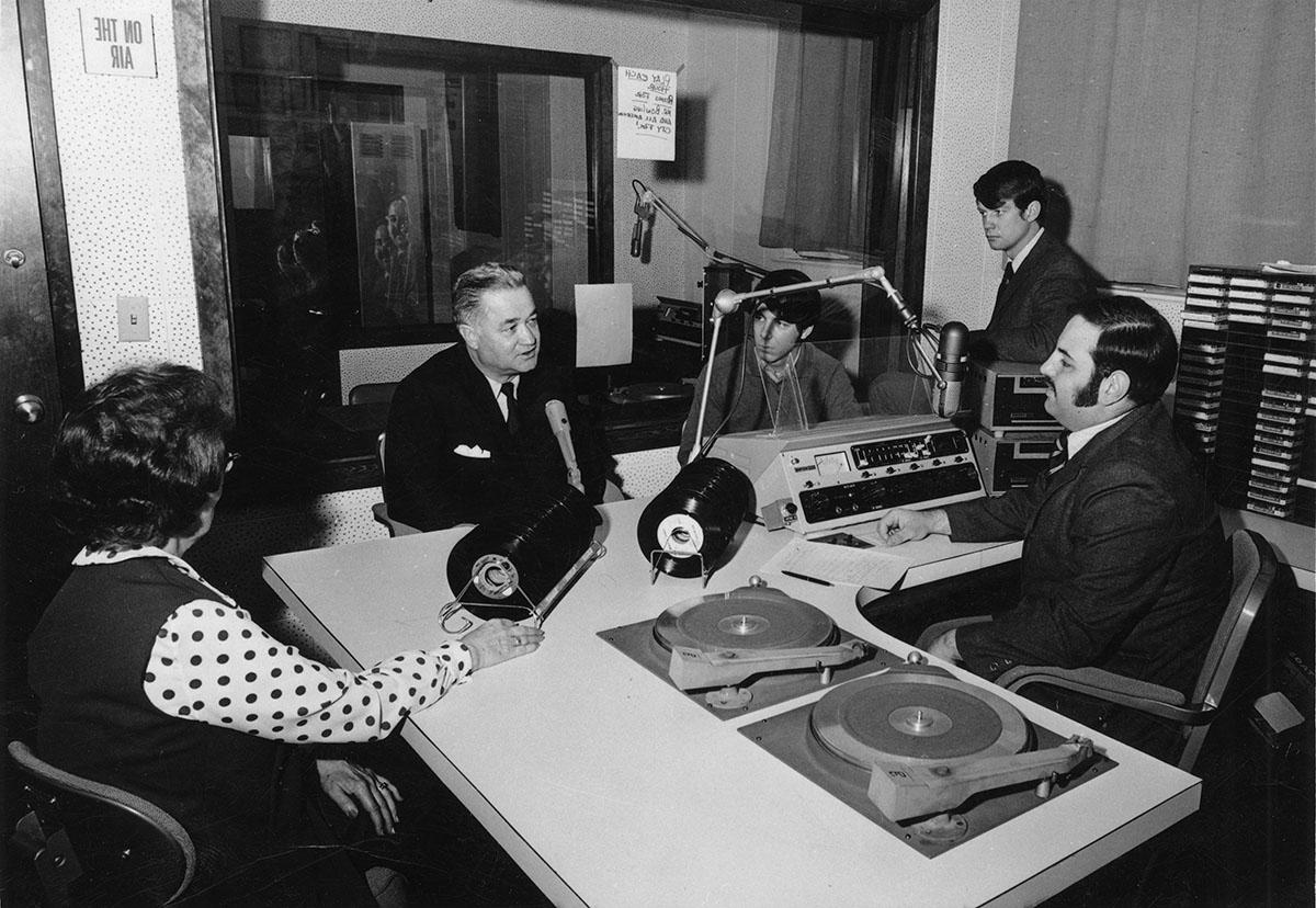 Robert Foster, who was instrumental in pushing for enhancements to Northwest's radio broadcast studios, talks with KDLX staff members in 1970.