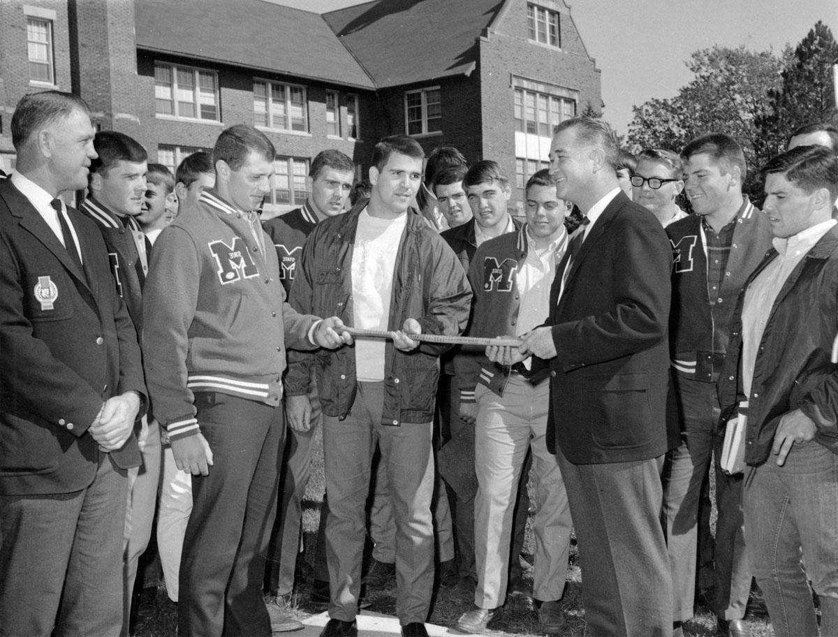 Foster receives the Old Hickory Stick after the Bearcat football team won it back from Northeast Missouri State University in 1969. 