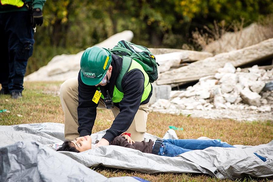 A first responder assists a victim during Friday's annual Missouri Hope emergency response field training exercise. (Photo by Lauren Adams/Northwest Missouri State University)